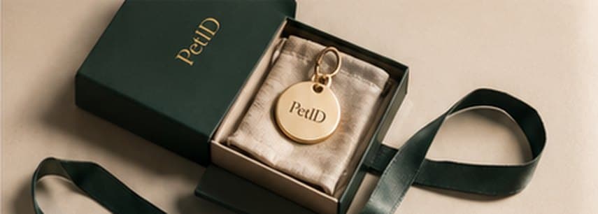 A PetID gift box with a tag resting on a ribbon